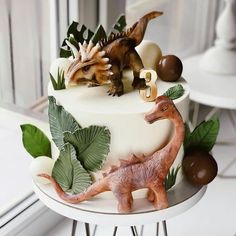 there is a cake decorated with dinosaurs on it