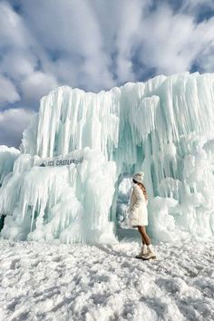 a woman standing in front of an ice castle