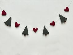 red and grey felt hearts are strung on a string