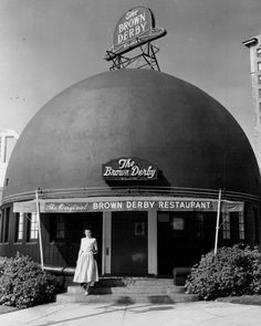 a woman standing in front of the brown derby