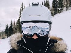 a person wearing skis and goggles in the snow