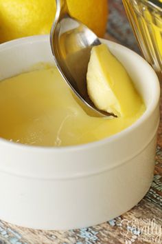 there is a spoon in a bowl with lemons