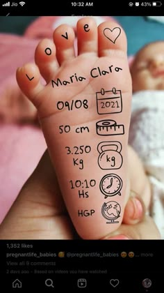 someone is holding their baby's foot with the birth date written on it in spanish