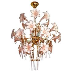 a chandelier with white flowers hanging from it's center point, on a white background