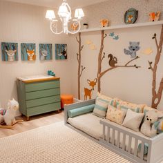 a baby's room with a crib, dresser and toy animals on the wall