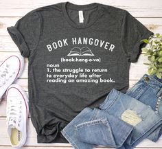 a t - shirt that reads book hangover with an open book next to it