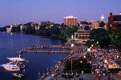 an aerial view of a harbor with boats in the water and people walking along it