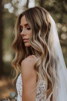 a woman with long blonde hair wearing a wedding veil