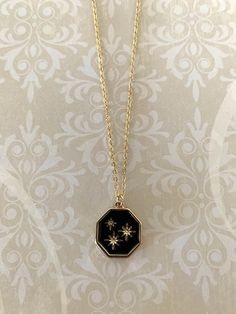 "Pretty gold tone 8 point stars on black enamel with gold edging octagon shaped necklace, gold stars necklace, stars necklace, stars on black, black star necklace, octagon necklace, necklace star.  Pendant measures 3/4\" in diameter and is on an 18\" chain.   ★ Want to see more?  Please visit my shop at: https://www.etsy.com/shop/DesignsByPeg"