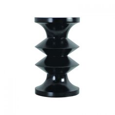 a black vase sitting on top of a white table