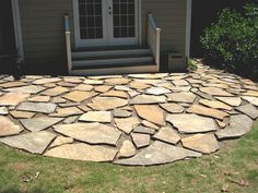 a stone patio in front of a house