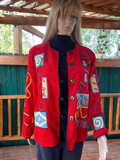 Beautiful, vibrant red jacket, with several large round polka dots buttons closing down the front. Round neck, long sleeves, entirely lined in black. Very colorful patches of different designs are sewn all over the jacket, making it quite unique. Trimmed in black rope  all over. Excellent condition. Size about Medium, but please check the measurements below.  Bust :  40"  Length from shoulder : 25"   Length of sleeves from shoulder : 23.5"   Width at bottom : 40" (it falls straight)     Neck opening : 22" Vintage Red Embroidered Outerwear, Embroidered Red Outerwear For Spring, Red Embroidered Outerwear For Spring, Embroidered Red Cardigan For Fall, Red Embroidered Fall Cardigan, Red Embroidered Long Sleeve Cardigan, Fitted Red Embroidered Outerwear, Casual Red Embroidered Outerwear, Red Embroidered Winter Cardigan