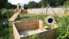 an outdoor play area with sand and toys