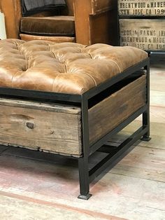 a leather ottoman sitting on top of a wooden floor