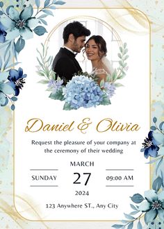 a wedding card with blue flowers and greenery on the front, in gold foil