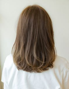 the back of a woman's head with long brown hair