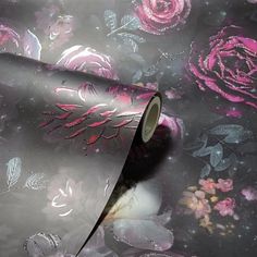 a roll of metallic foil with pink roses on it and purple flowers in the background