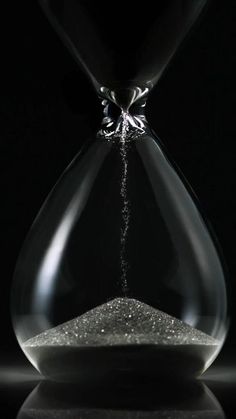 an hourglass with sand coming out of it