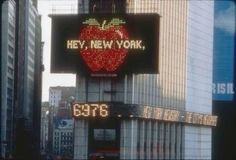 the new york times square sign has an apple on it's backlit display