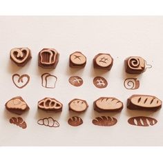 wooden stamps with different types of breads and pastries in them on a white surface