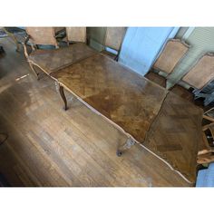 an old wooden table and chairs in a room with hard wood flooring that has been stripped off