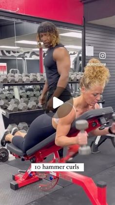 a woman is doing exercises on a bench in the gym while another man looks on