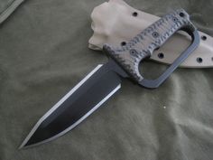 a large knife laying on top of a cloth