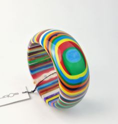 This bangle is part of the Pop Art line. The Pop Art line was created by Sobral to represent the passage of Modernity into Post Modernity in the Western culture. This bracelet is called PB14 and this is the Day version which features a bright vibrant rainbow stripe and eye motif. It measures 1 3/8" wide and the interior diameter is 2 5/8". I also have necklaces, earrings and rings available in this pattern. The first United Nations Conference to address environmental degradation was held in Stoc Eye Motif, Environmental Degradation, Western Culture, Handcrafted Artisan Jewelry, Art Line, Old Lady, United Nations, Fabric Jewelry, Rainbow Stripes