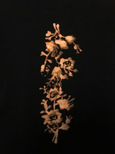 a black shirt with white flowers on the front and back side, in an image that appears to have been altered