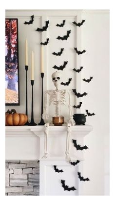 a fireplace with candles and halloween decorations on it