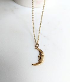 Man in the Moon Face Necklace 🌛 The detailed pendant is made of brass and then plated in high quality matte gold. The chain is either gold filled or gold plated, with a $5 difference in the cost, just choose which material and length you would like before checkout 🌒 I have so many celestial items in my shop, this looks so good layered with my other items! I pair it with my gold labradorite choker ✨ Hope you're finding some peace during the quarantine. Thanks for supporting me, especially durin Moon Shaped Brass Necklace With Moon Charm, Brass Moon-shaped Necklace With Moon Charm, Brass Moon Charm Jewelry, Crescent Moon Phase Brass Necklace, Minimalist Brass Moon Jewelry, Brass Crescent Moon Phase Necklace, Minimalist Moon-shaped Brass Jewelry, Half Moon Moon Phase Brass Jewelry, Minimalist Moon Shaped Brass Jewelry