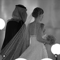 the bride and groom are dressed up in traditional arabic garb for their wedding ceremony