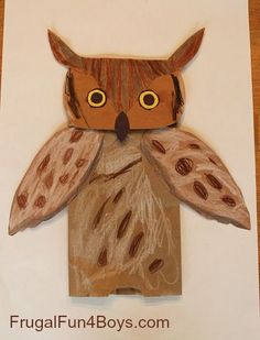 an owl made out of cardboard sitting on top of a piece of paper