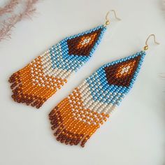 These long beaded earrings are inspired by native American patters. Handcrafted with meticulous attention to detail, they exude timeless sophistication. Perfect for adding a touch of celestial charm to any ensemble, these earrings are sure to become a cherished addition to your jewelry collection. Dimensions: - Length: 10 cm (3.9 inches) - Width: 3 cm (1.2 inches) Bohemian Teardrop Earrings With Large Beads, Bohemian Dangle Earrings With Large Beads, Bohemian Long Drop Earrings With Colorful Beads, Southwestern Dangle Beaded Earrings For Festivals, Southwestern Style Beaded Dangle Earrings For Festival, Southwestern Style Dangle Beaded Earrings For Festivals, Bohemian Teardrop Beaded Fringe Jewelry, Bohemian Orange Tassel Earrings For Festivals, Bohemian Drop Earrings With Large Beads