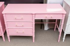 two pink desks are next to each other