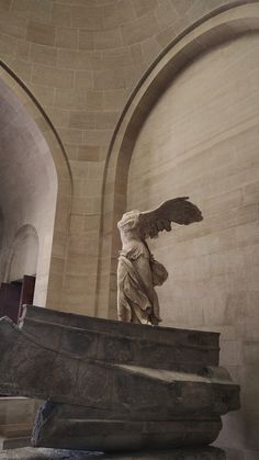 an angel statue in the middle of a building