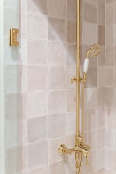 a gold shower head with thermostaer and hand held shower faucet