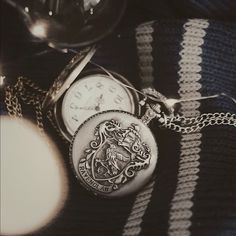 a harry potter pocket watch on a striped blanket