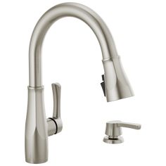 a kitchen faucet with two handles and one side sprayer on the sink