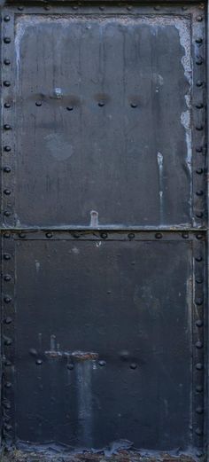 an old metal door with rivets on it