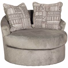 a large round chair with two pillows on it's back and the seat upholstered