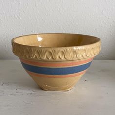 a bowl sitting on top of a white table