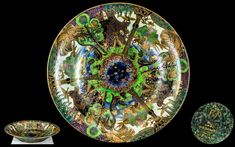 an ornately decorated plate next to two plates with decorative designs on them, all in gold and green