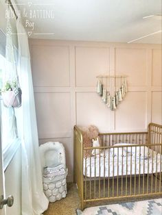 a baby's room with a crib, rugs and wall hangings