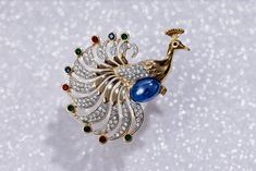 "Vintage Puccini peacock gold tone crystal rhinestones green, blue, red, Cabochon Pin Brooch. Marked PC for Puccini.  It is approx. 2.5\" x 2.25\" The brooch is in great vintage condition. There are no missing stones. Please review photos for full description of condition." Elegant Party Brooch With Peacock Design, Gold Brooches With Peacock Design As Gift, Elegant Peacock Design Brooch For Formal Occasions, Elegant Peacock Color Party Brooches, Elegant Peacock Design Brooch For Formal Wear, Elegant Multicolor Jeweled Brooches, Elegant Multicolor Rhinestone Brooches, Peacock Jewelry, Solid Perfume