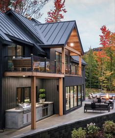 an outdoor kitchen and living room are located on the side of this house