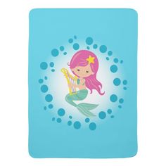 a little mermaid with pink hair playing the harp on a blue sheet that has circles around it