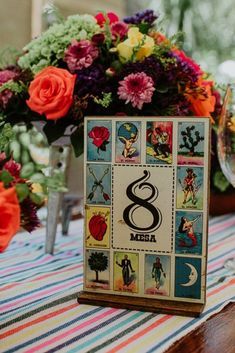 the table is decorated with colorful flowers and cards