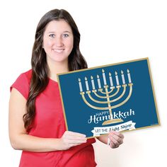 a woman holding up a hanukkah sign