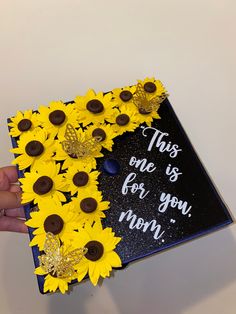 a graduation cap decorated with sunflowers and chocolate